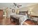 Comfortable bedroom featuring hardwood floors, a decorative wood bed, and ensuite bathroom at 902 W Moon Valley Dr, Phoenix, AZ 85023
