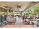 This home features a spacious covered patio perfect for relaxing and entertaining with comfortable seating and ceiling fans at 902 W Moon Valley Dr, Phoenix, AZ 85023