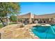 Picturesque backyard with a custom pool, spa, covered patio, outdoor kitchen and mature shade trees at 902 W Moon Valley Dr, Phoenix, AZ 85023