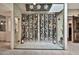 A wine cellar with glass walls and racks of wine bottles at 902 W Moon Valley Dr, Phoenix, AZ 85023