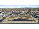 Expansive aerial view of a neighborhood featuring a playground and a serene pond at 10150 E Thistle Ave, Mesa, AZ 85212