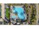 Stunning aerial view of a community pool surrounded by lush palm trees and lounge chairs at 10150 E Thistle Ave, Mesa, AZ 85212