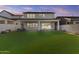 Expansive backyard features artificial turf, a covered patio, and a two-story home at 10150 E Thistle Ave, Mesa, AZ 85212
