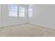 Bright, spacious bedroom with neutral carpet and fresh white walls at 10150 E Thistle Ave, Mesa, AZ 85212