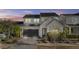 Charming two-story home featuring a modern garage door and well-manicured landscaping at 10150 E Thistle Ave, Mesa, AZ 85212