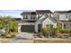 Attractive two-story home showcasing a sleek garage door and appealing front yard landscaping at 10150 E Thistle Ave, Mesa, AZ 85212