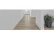 Bright hallway featuring hard surface floors, fresh paint, and a decorative plant at 10150 E Thistle Ave, Mesa, AZ 85212