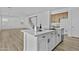 Modern kitchen island featuring a marble countertop, stainless sink, and dishwasher at 10150 E Thistle Ave, Mesa, AZ 85212