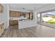 Bright kitchen with modern stainless steel appliances and an island, with an open view to the yard at 10150 E Thistle Ave, Mesa, AZ 85212