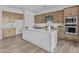 Spacious kitchen with an island, modern appliances, wooden cabinets, and white marble countertops at 10150 E Thistle Ave, Mesa, AZ 85212