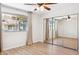 Bedroom with wood-look floors, closet with mirrored doors, a window, and ceiling fan at 1021 S Greenfield Rd # 1106, Mesa, AZ 85206