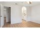 This bright bedroom features wood-look floors, neutral walls, and an arched doorway to the bathroom at 1021 S Greenfield Rd # 1106, Mesa, AZ 85206