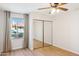 Bright bedroom featuring wood-look floors, neutral walls, and closet with mirrored doors at 1021 S Greenfield Rd # 1106, Mesa, AZ 85206