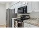 Bright kitchen featuring stainless steel appliances, granite counters, and modern fixtures at 1021 S Greenfield Rd # 1106, Mesa, AZ 85206