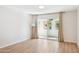 Bright living room with wood floors, curtains, sliding door to balcony and neutral tones at 1021 S Greenfield Rd # 1106, Mesa, AZ 85206
