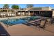 Inviting community pool area with lounge chairs and a covered area, perfect for relaxation and enjoying the outdoors at 1021 S Greenfield Rd # 1106, Mesa, AZ 85206