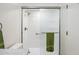 Walk-in shower with clear glass door and a green towel hanging on a grab bar at 1021 S Greenfield Rd # 1106, Mesa, AZ 85206