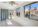 Bright sunroom featuring tiled floors, multiple windows, and a glass door with views of the home's backyard at 1021 S Greenfield Rd # 1106, Mesa, AZ 85206