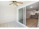 Bright sunroom featuring tiled floors, a ceiling fan and sliding glass doors leading to a kitchen and living area at 1021 S Greenfield Rd # 1106, Mesa, AZ 85206