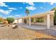 Covered patio overlooking a landscaped backyard featuring decorative rock and mature trees at 10634 E Cedar Waxwing Dr, Sun Lakes, AZ 85248