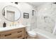 Stylish bathroom features marble tile in the shower, modern vanity, gold fixtures, and a round mirror at 10634 E Cedar Waxwing Dr, Sun Lakes, AZ 85248