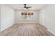 Bright bedroom featuring a ceiling fan, a large window with wooden-style blinds, and wood-look flooring at 10634 E Cedar Waxwing Dr, Sun Lakes, AZ 85248