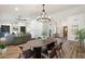 Open-concept floorplan includes dining area with hardwood floors and wood table at 10634 E Cedar Waxwing Dr, Sun Lakes, AZ 85248
