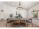 Dining room features a vaulted ceiling, chandelier, and views of backyard at 10634 E Cedar Waxwing Dr, Sun Lakes, AZ 85248
