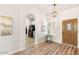 Inviting entryway showcasing hardwood floors, stylish lighting, and arched doorways at 10634 E Cedar Waxwing Dr, Sun Lakes, AZ 85248
