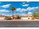 Charming single-story home featuring a red tile roof, desert landscaping, and palm trees at 10634 E Cedar Waxwing Dr, Sun Lakes, AZ 85248