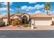 Inviting single-story home with desert landscaping, red door, and attached two-car garage at 10634 E Cedar Waxwing Dr, Sun Lakes, AZ 85248