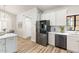 Modern kitchen featuring stainless steel appliances, white cabinets, and hardwood floors at 10634 E Cedar Waxwing Dr, Sun Lakes, AZ 85248