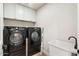 Well-equipped laundry room with modern washer, dryer, sink and storage space at 10634 E Cedar Waxwing Dr, Sun Lakes, AZ 85248