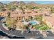 Bird's eye view of the condo community with pool, parking, desert landscape and mountain backdrop at 10655 N 9Th St # 207, Phoenix, AZ 85020