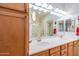 Spacious bathroom featuring double sinks, ample cabinet space, a large mirror, and a bright, airy design at 10655 N 9Th St # 207, Phoenix, AZ 85020