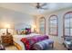 Serene bedroom with arched windows, complemented by stylish furnishings and a calming color palette at 10655 N 9Th St # 207, Phoenix, AZ 85020