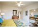 Bright bedroom with a ceiling fan, dresser, and mirrored closet, providing ample space and comfort at 10655 N 9Th St # 207, Phoenix, AZ 85020