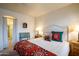 Comfortable bedroom showcasing a decorative bed, classic furnishings, and an inviting, tranquil atmosphere at 10655 N 9Th St # 207, Phoenix, AZ 85020