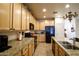 Well-lit kitchen with granite countertops and stainless steel sink and black appliances at 10655 N 9Th St # 207, Phoenix, AZ 85020
