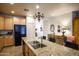 Open kitchen with granite countertop island leading to decoratively furnished room at 10655 N 9Th St # 207, Phoenix, AZ 85020