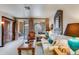 Bright living room with sliding glass doors to the outside balcony featuring unique decor at 10655 N 9Th St # 207, Phoenix, AZ 85020