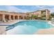 Inviting community pool area with lounge chairs, umbrellas, and landscaped surroundings for a resort-like experience at 10655 N 9Th St # 207, Phoenix, AZ 85020