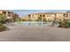 Community pool with ample seating surrounded by lush greenery, offering a relaxing outdoor space at 10655 N 9Th St # 207, Phoenix, AZ 85020