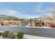 View of a desert neighborhood lined with well-maintained homes and palm trees at 10655 N 9Th St # 207, Phoenix, AZ 85020