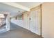 Hallway leading to unit with white security door, light fixture, and windows at 10807 N Fairway W Ct # 212, Sun City, AZ 85351