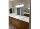 Bathroom featuring dual sinks, bright lighting, and large mirror at 11500 E Cochise Dr # 1063, Scottsdale, AZ 85259