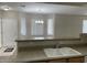 Bright kitchen area featuring a dual basin sink, breakfast bar, and neutral walls at 11500 E Cochise Dr # 1063, Scottsdale, AZ 85259