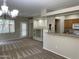 Open concept living and kitchen area with modern chandelier, and neutral walls at 11500 E Cochise Dr # 1063, Scottsdale, AZ 85259