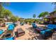 Lounge by the pool area with blue cushion seating, ideal for community residents at 11500 E Cochise Dr # 1063, Scottsdale, AZ 85259