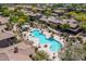 Aerial view of a large community pool with lounge chairs and desert landscaping at 11500 E Cochise Dr # 1063, Scottsdale, AZ 85259